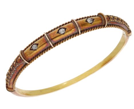 A late 19th century diamond bangle, the hinged bangle set to the front with three old brilliant-cut diamonds, with granulatio