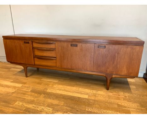 A 1960s teak sideboard by Greaves & Thomas standing on an afromosia frame with two large compartments with adjustable shelvin
