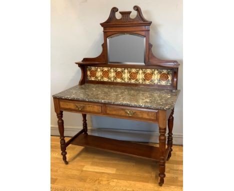A late Victorian walnut and mahogany wash stand, tiled back marble top with twin drawers and lower shelf, raised on turned le