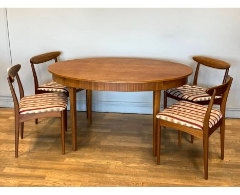 A 1960s teak dining suite by Greaves & Thomas comprising of an extending oval dining table with four matching dining chairs -