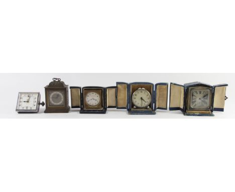 A collection of early 20th Century manual wind travel alarm clocks, three with original cases, together with a 1920's Jaeger 