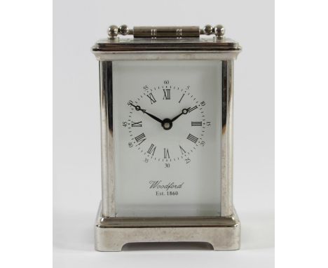 A Woodford Obis 8 day carriage clock chrome plated solid brass casing with beveled edge glass panels and white enameled dial.