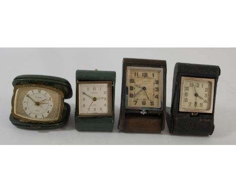 A 1920s Art Deco traveling alarm clock by Jaeger-Le Coultre with eight day movement together with three other examples includ