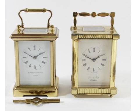 A Lionel Peck of London 8 day carriage clock brass cased with bevel edged glass panels, white enameled dial and roman numeral