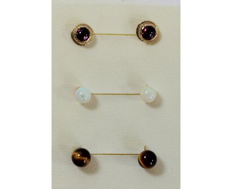 Three pairs of 9ct gold ear studs, tigers eye, opal and garnet 