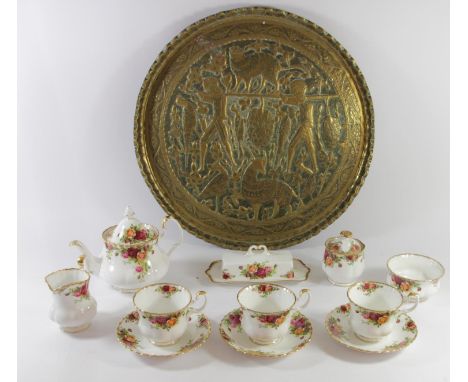 A Royal Albert eight piece tea service, together with a large oriental brass charger with highly embossed & hammered decorati