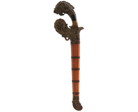 AN INDONESIAN TUMBOK OR KRIS, 19cm double fullered watered steel blade, characteristic foliate carved hilt, contained in its 