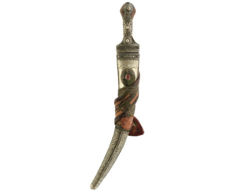 A WAHABITE JAMBIYA, 34cm sharply curved blade, characteristic white metal filigree decorated hilt with two-piece wooden grips