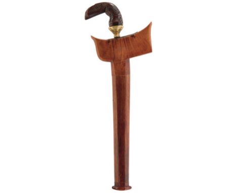 A MALAYAN KRIS, 33cm wavy watered steel blade, characteristic wooden hilt finely carved with scrolling foliage, brass collar,