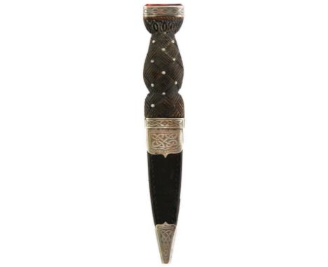 A VICTORIAN SGEAN DUBH, 9.5cm fullered blade with faceted back edge and clipped back tip, characteristic white metal mounted 