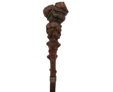 A 19TH CENTURY BLACK FOREST WALKING STICK, the pommel carved in the shape of a crouching man, on briar haft with woven white 
