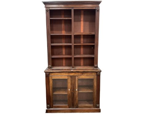 Early Victorian mahogany library bookcase on cupboard, projecting cornice over applied floral roundels and egg and dart beadi