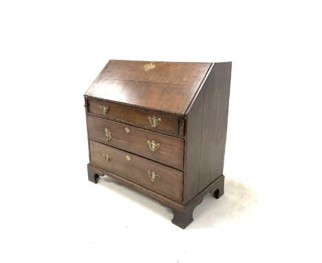 19th century oak bureau, the cross banded fall front revealing interior fitted with drawers and cubby holes, over three long 