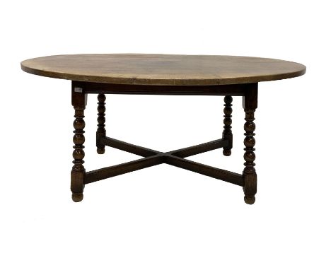 Titchmarsh and Goodwin solid oak dining table, the oval top raised on bobbin turned and block supports, united by 'X' stretch