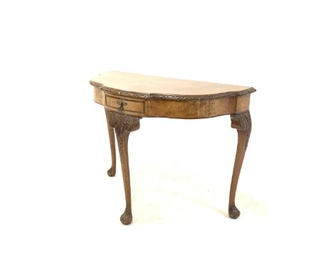 20th century Queen Anne style burr walnut serpentine bow front console table, the cross banded top with floral moulded edge o