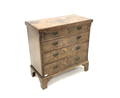 Early 20th century figured walnut bachelors chest, fold over top over four long graduated drawers, raised on shaped bracket s