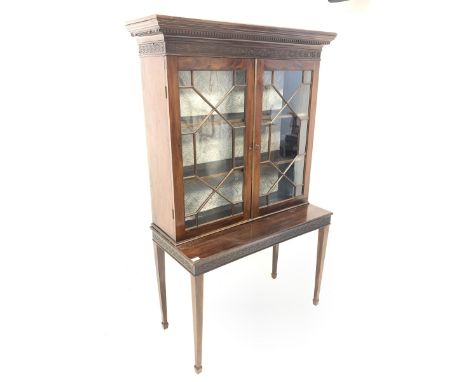 Early 20th century Chippendale style mahogany bookcase on stand, dentil cornice over carved frieze and two astragal glazed do