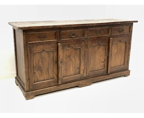 Rustic solid oak sideboard, fitted with four drawers and two double cupboards each enclosing a fixed shelf, 181cm x 60cm, H90