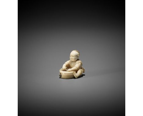 TOSHIMASA: A TOKYO SCHOOL IVORY NETSUKE OF A BOY TEARING APART A TAIKO DRUM By Toshimasa, signed Toshimasa 利正Japan, Tokyo, Me