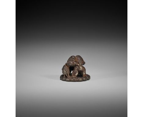 HEIZO: A DARK WOOD NETSUKE OF TWO SHOJO WRESTLING AND TORTOISE REFEREE By Heizo, signed Heizo 柄造Japan, 19th century, Edo peri