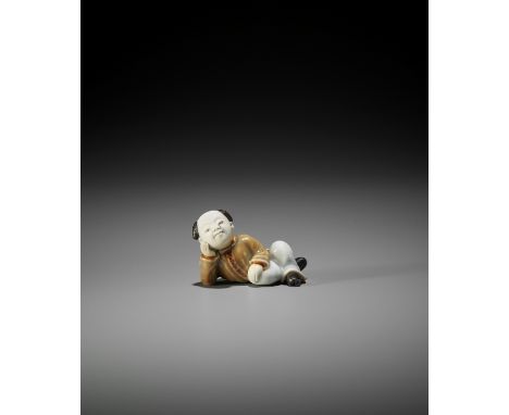 A FINE HIRADO PORCELAIN NETSUKE OF A KARAKO RESTING Unsigned Japan, second half of 19th centuryThe boy lying on the ground wi