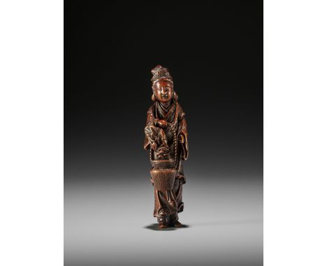 HASEGAWA IKKO: A TALL AND FINE WOOD NETSUKE OF SEIOBO By Hasegawa Ikko, signed Ikko 一虎Japan, early 19th century, Edo period (