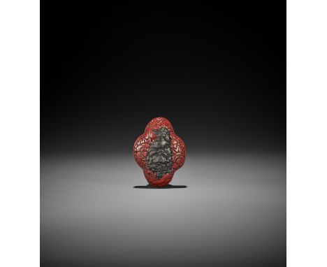 A TSUISHU LACQUER NETSUKE WITH SHISHI AND PEONY UnsignedJapan, 19th century, Edo period (1615-1868)The netsuke in the shape o