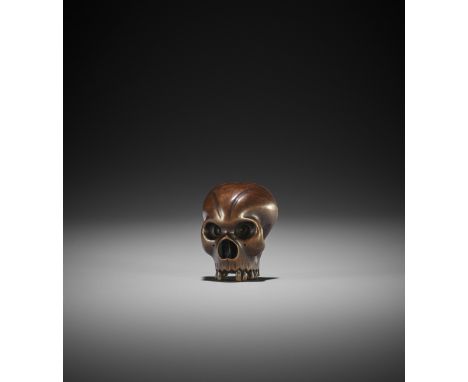 A FINE WOOD NETSUKE OF A FRACTURED SKULL UnsignedJapan, 19th century, Edo period (1615-1868)A finely carved wood netsuke of a