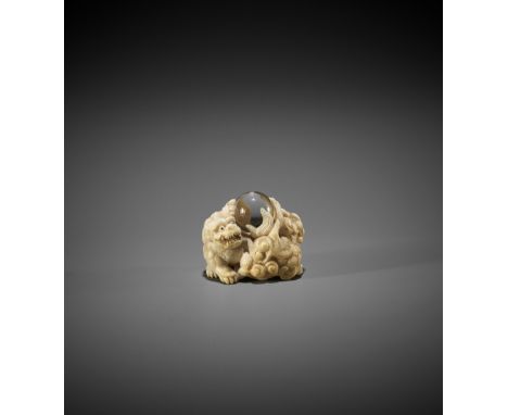 KAGETOSHI: AN IVORY NETSUKE OF TWO SHISHI WITH ROCK CRYSTAL TAMA By Kagetoshi, signed Kagetoshi 景利Japan, mid-19th century, Ed