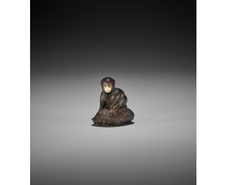 SO: A FINE AND CHARMING TOKYO SCHOOL WOOD NETSUKE OF A MONKEY SEATED ON A MINOGAME Signed So 宗 with a kakihanJapan, Edo/Tokyo