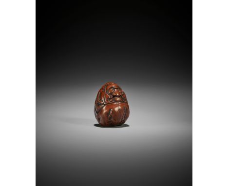 A KURUMI (WALNUT) NETSUKE OF DARUMA, ATTRIBUTED TO HIDARI ISSAN Attributed to Hidari Issan, unsignedJapan, Iwashiro, early 19