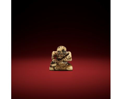 AN EARLY STAG ANTLER NETSUKE OF AN ONI PLAYING THE SAMISEN UnsignedJapan, 18th century, Edo period (1615-1868)The oni seated 