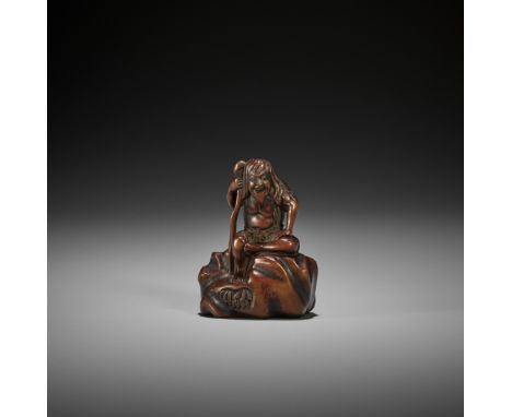 GYOKURINTEI: A WOOD NETSUKE OF TEKKAI SENNIN SEATED ON A ROCK By Gyokurintei, signed Gyokurintei 玉林亭Japan, Edo (Tokyo), c. 18