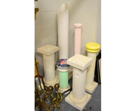 A wrought iron tripod standard lamp, a pair of 17th century style brass andirons, a pair of modern plaster columns, 76cm high