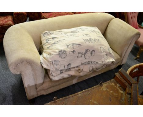 A cream upholstered drop end roll top sofa