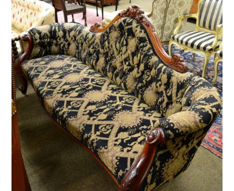 A Victorian carved mahogany sofa, with buttoned back 