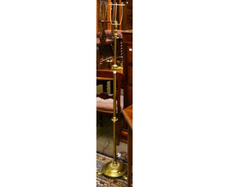 An Art Nouveau brass adjustable standard lamp with stylised base