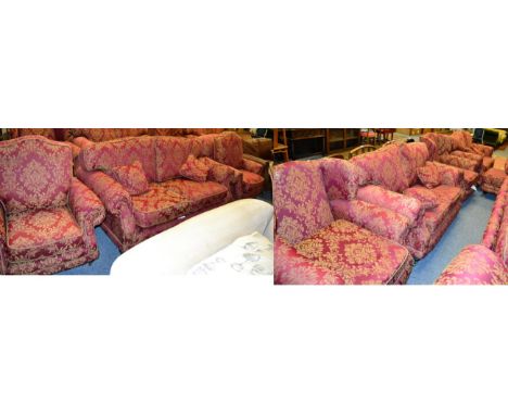 A Kirkdale red and gold upholstered eight piece suite comprising a three seater sofa, a pair of armchairs, a pair of two seat