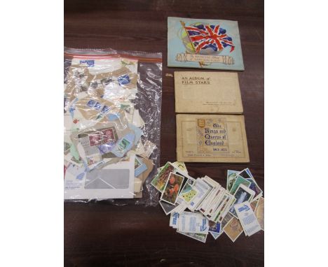 Vintage cigarette card books, loose modern cards and a bag of circulated stamps