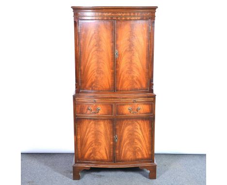 Reproduction mahogany cocktail cabinet, bowfront, the upper section birch lined and with mirrored panel, drawers and cupboard