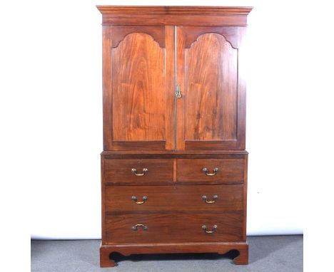 Victorian mahogany linen press, moulded cornice, two panelled doors enclosing four sliding trays, the base with two short and