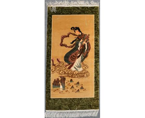 Modern Chinese figural rug, the camel-coloured field with a lady holding a scroll in clouds, olive green border, with a baton