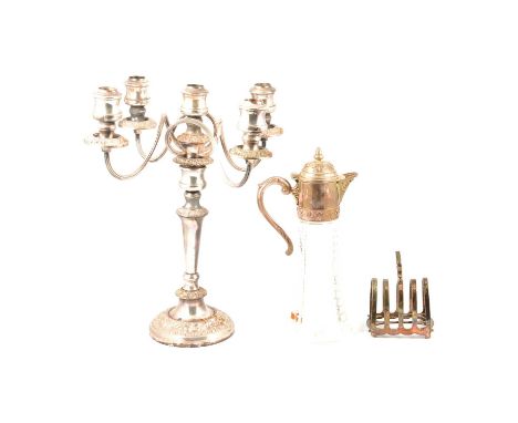 A glass claret jug with plated mounts; four bottle cruet; metal alloy desk stand with pen rest (missing bottles); five light 