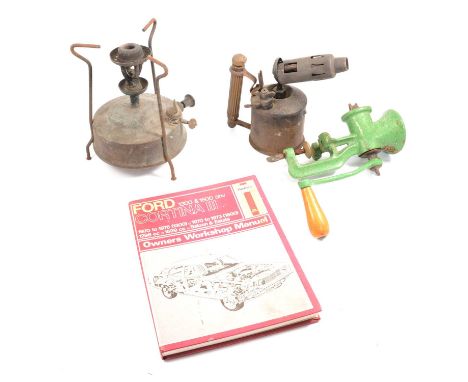 Box of tools, blow lamp, wood plane, paraffin stove, mincer, car manuals.