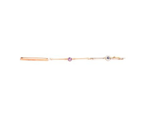 Three yellow metal bar brooches, a 57mm sapphire and diamond yellow metal bar brooch, the round brilliant cut sapphire to the