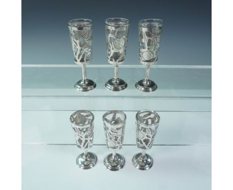 A vintage set of six handblown cordial glasses featuring intricate sterling silver overlay with floral and foliate motifs. Ea