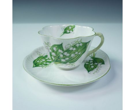 Decorated in the classic Lily of the Valley pattern, this Shelley teacup and saucer set features graceful white bell-shaped f