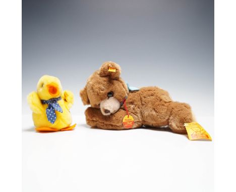 Pair of vintage Steiff plush animals featuring a brown floppy bear and a bright yellow duckling. The bear wears a blue ribbon