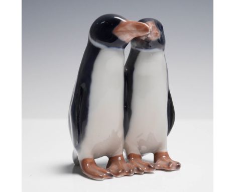 Charming Royal Copenhagen figurine depicting a pair of affectionate penguins standing closely side by side. This piece was cr