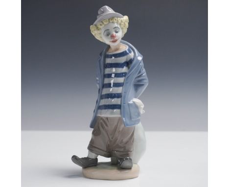 This Lladro Collectors Society exclusive figurine, titled Little Traveler, depicts a whimsical clown dressed in a striped shi